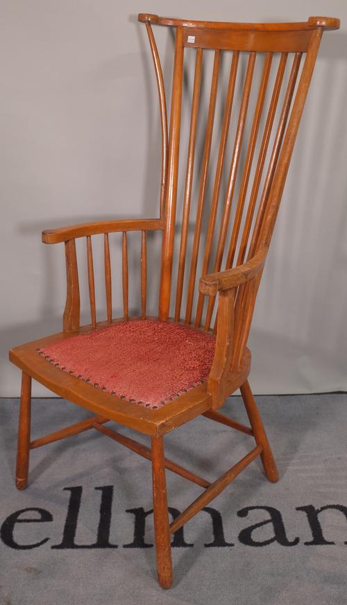 An early 20th century beech stick back armchair on tapering supports.