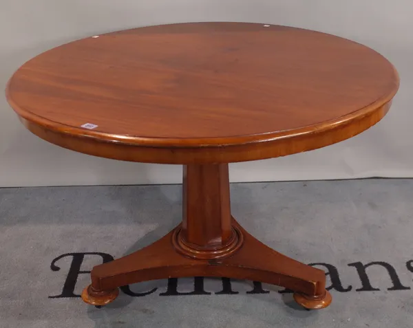 A Regency style mahogany circular centre table on octagonal tapering column on bun feet, 104cm wide x 80cm high.