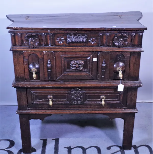 A 17th century and later oak side cabinet with lift top over two long drawers on block supports, 92cm wide x 82cm high.