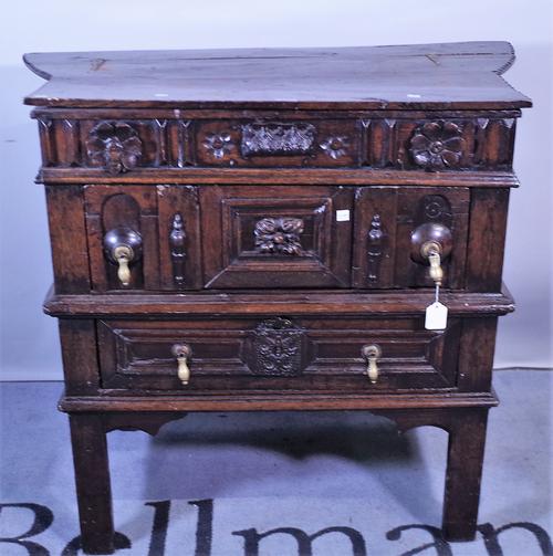 A 17th century and later oak side cabinet with lift top over two long drawers on block supports, 92cm wide x 82cm high.