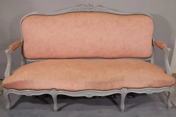 A Louis XV style open arm sofa with grey painted floral and shell moulded frame and serpentine seat on scroll supports, 185cm wide x 110cm high.