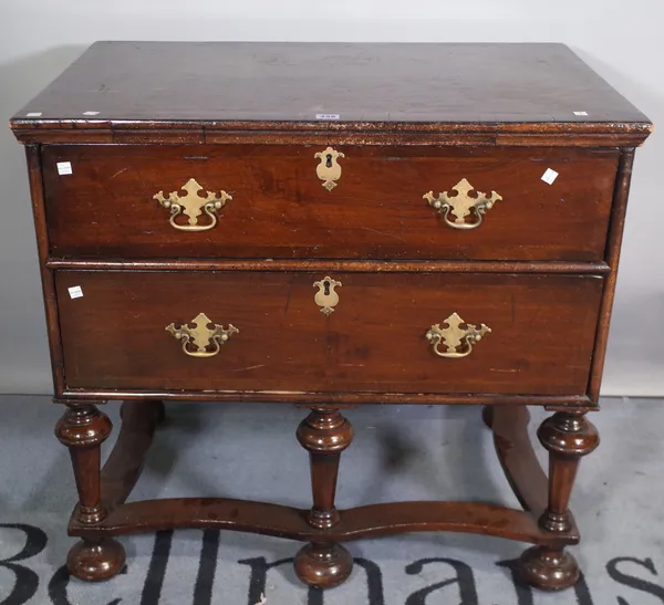 A Queen Anne low chest of two short drawers on bun feet, 86cm wide x 79cm high.