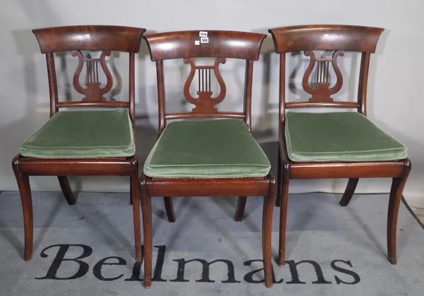 A set of six early 19th century French mahogany framed dining chairs with lyre backs on sabre supports, 48cm wide x 88cm high, (6).