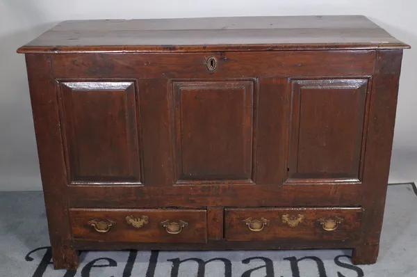 An 18th century oak mule chest with triple panel front over pair of drawers, on block feet, 125cm wide x 83cm high.