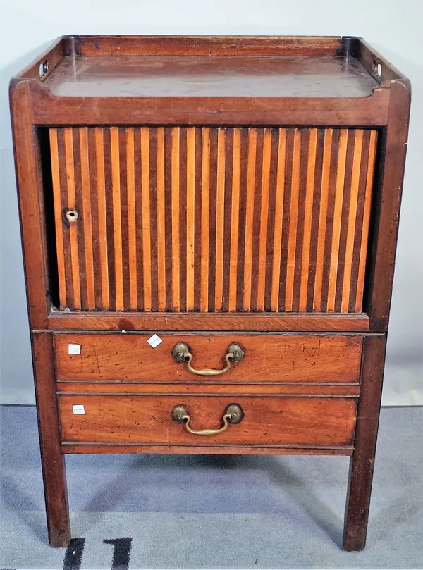 A George III mahogany tambour fronted commode, with galleried top, on block supports, 56cm wide x 83cm high.