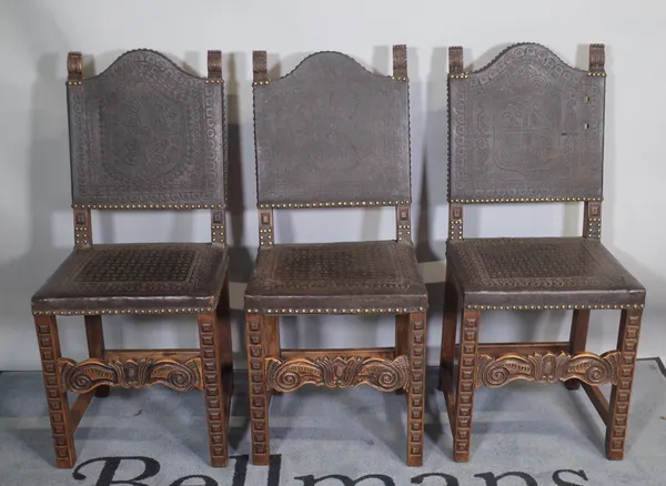 A set of six 17th century Spanish style walnut framed dining chairs, with studded embossed leather upholstery, 42cm wide x 99cm high, (6).