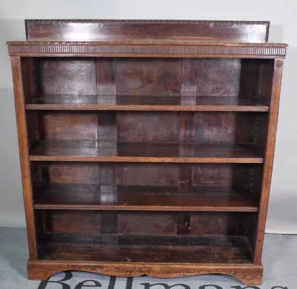 An early 20th century oak four tier open bookcase on bracket feet, 114cm wide x 122cm high.