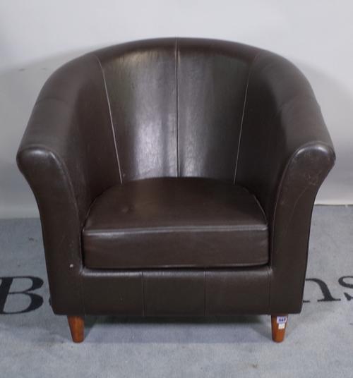 A 20th century tub back club chair on tapering turned supports, 80cm wide x 74cm high.
