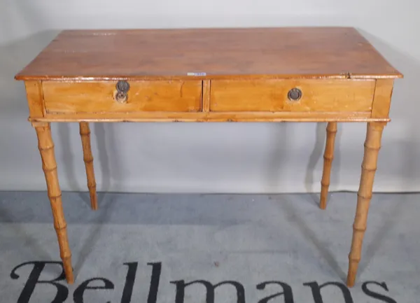 A 19th century pine two drawer side table, on faux bamboo supports, 104cm wide x 76cm high.