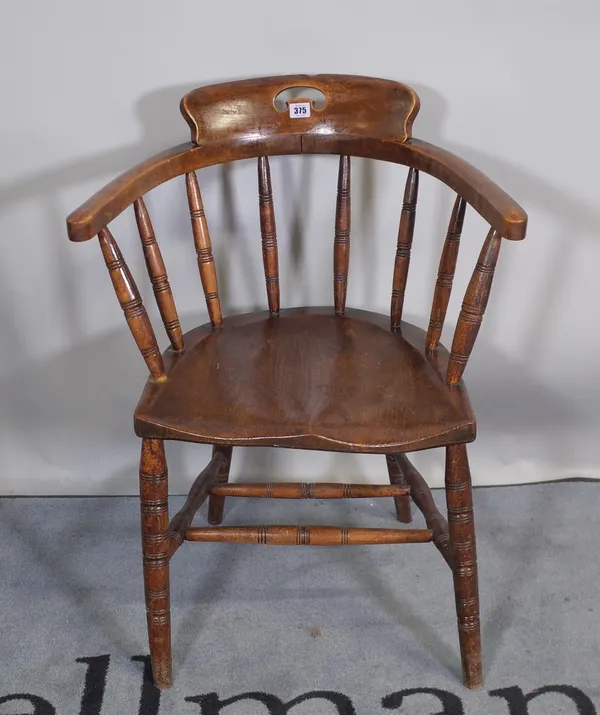 A Victorian ash and elm smoker's chair on ring turned supports.