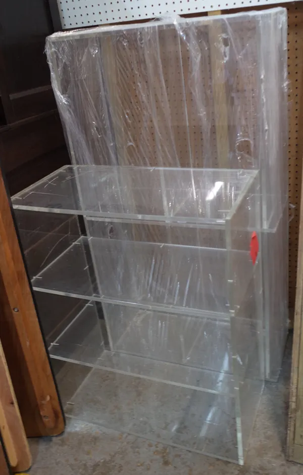 A pair of 20th century perspex three tier open bookcases, 101cm wide x 81cm high, (2).  Provenance; property from the late Sir David TangThis lot has