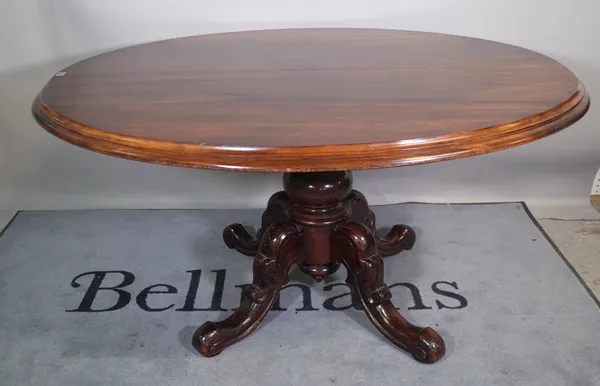 A Victorian style mahogany oval tilt top dining table on four downswept supports, 145cm wide x 76cm high.