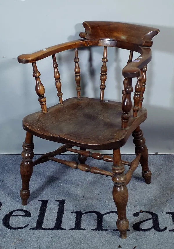 A late 19th century ash and elm smokers armchair.