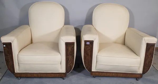 A pair of mid-20th century walnut veneered low armchairs with white leather upholstery, (2).