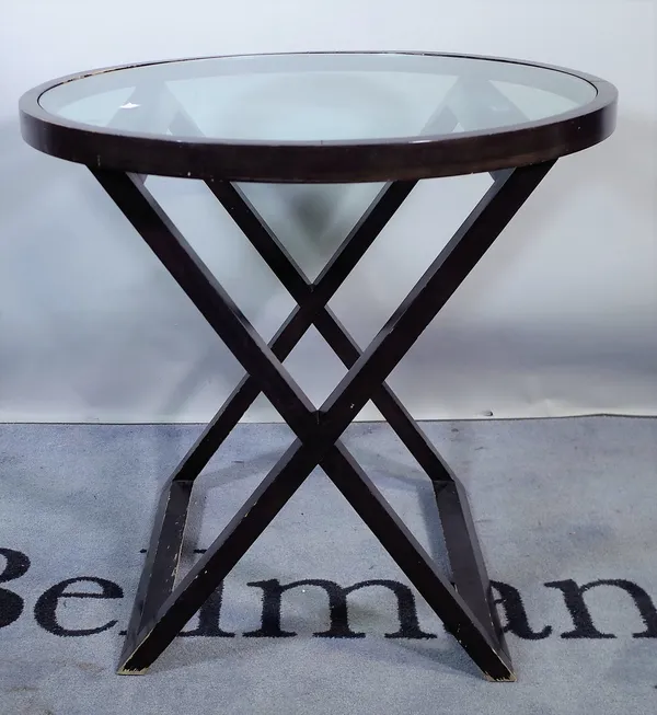 A 20th century hardwood circular dining table with inset glass top on 'X' frame base, 76cm wide x 74cm high.