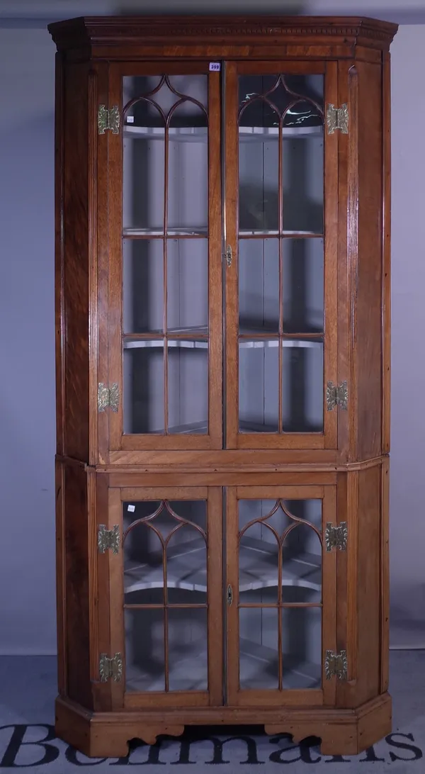 A George III mahogany double height corner display cabinet on bracket feet, 104cm wide x 213cm high.