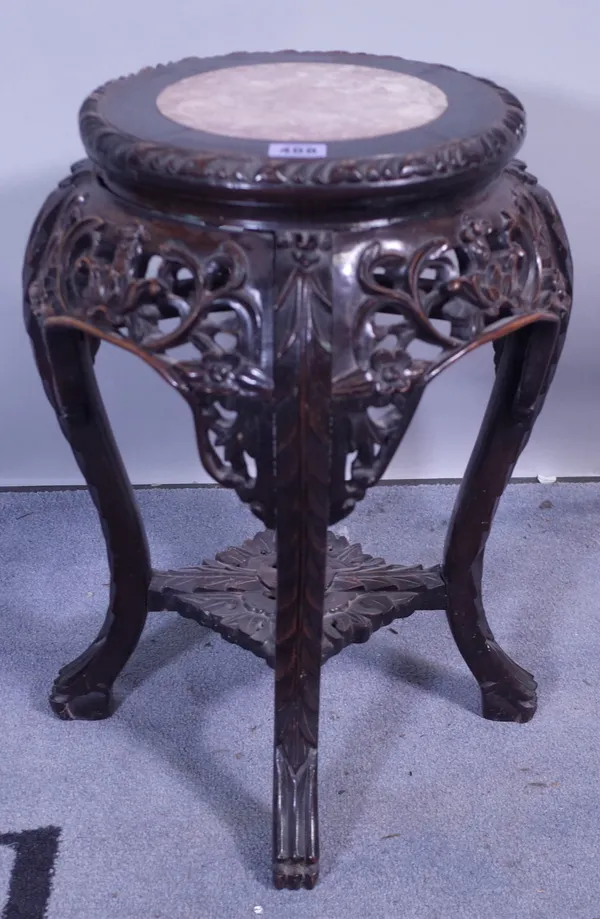 An early 20th century Chinese hardwood circular jardiniere stand, with inset marble top, 35cm wide x 48cm high.