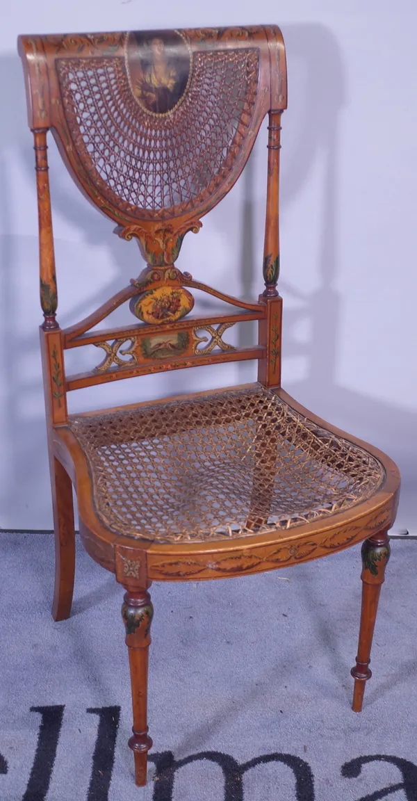 Circa 1900, an Edwardian satinwood  and polychrome painted bedroom chair with canework seat on tapering supports.