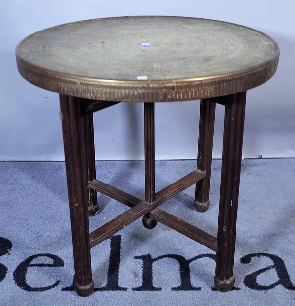 An early 20th century brass circular folding table on reeded mahogany base, 60cm wide x 60cm high.