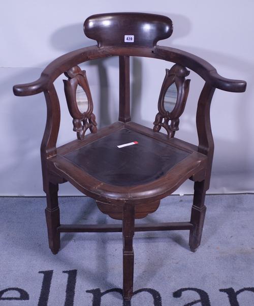 A 20th century Chinese hardwood corner chair with inset marble panelled back.  Provenance; property from the late Sir David TangThis lot has been impo