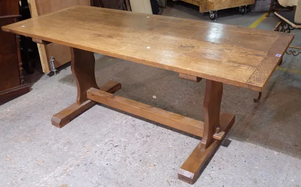 A 20th century oak refectory table united by block stretcher on dual end supports, 182cm long x 77cm wide x 75cm high.