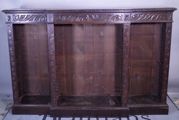 A late Victorian oak breakfront open bookcase, 183cm wide x 111cm high.