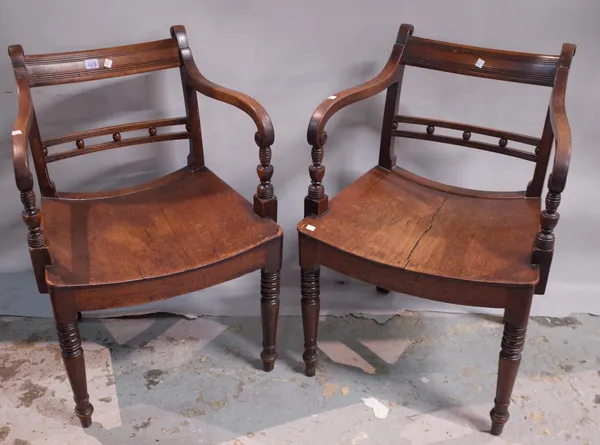 A pair of Regency mahogany and stained beech open armchairs on ring turned tapering supports, (2).