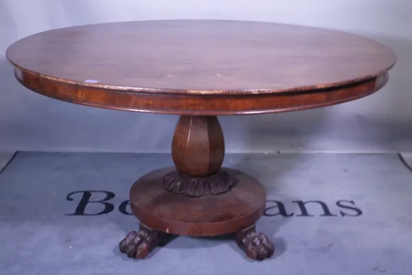 A Victorian mahogany circular dining able octagonal tapering column on plinth base supported by claw feet, 132cm wide x 78cm high.  Provenance; proper