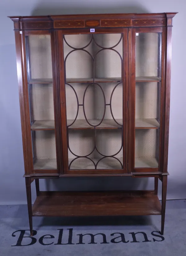 An Edwardian mahogany inlaid breakfront display cabinet on tapering supports, 121cm wide x 177cm high.