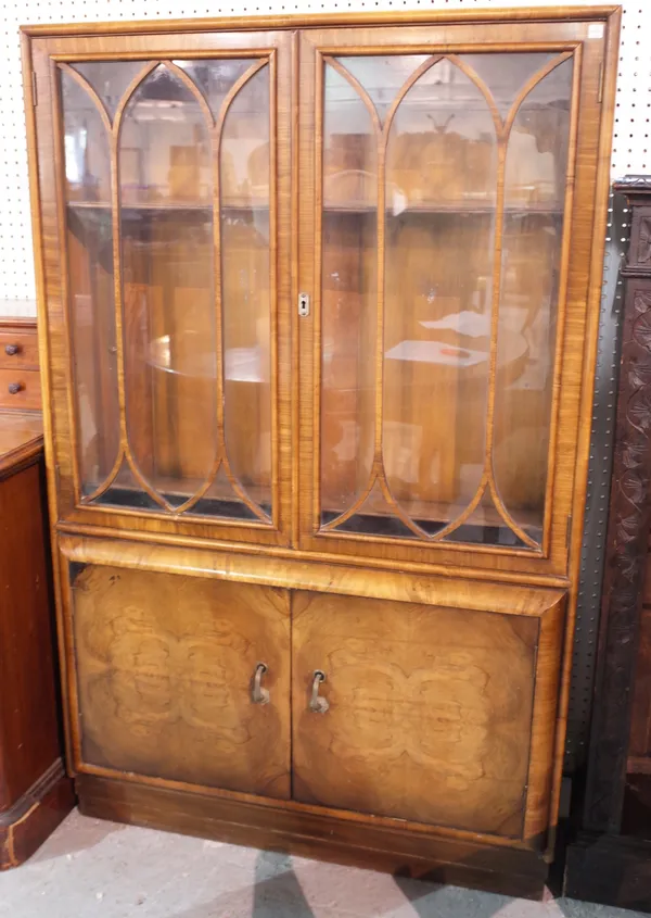 A 20th century walnut display cabinet with astragal glazed doors over cupboard , 91cm wide x 146cm high.