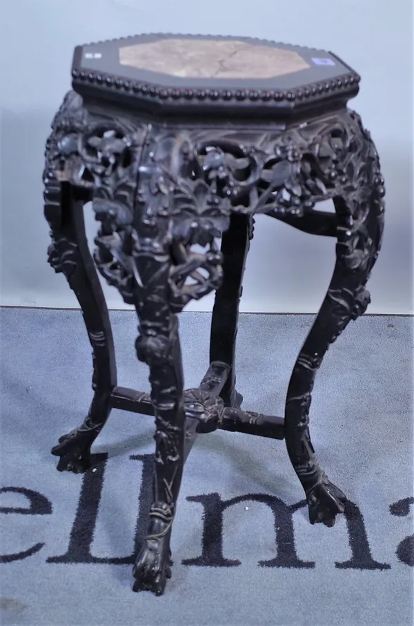 An early 20th century Chinese hardwood octagonal jardiniere stand with marble inset top, 35cm wide x 62cm high, (a.f.).