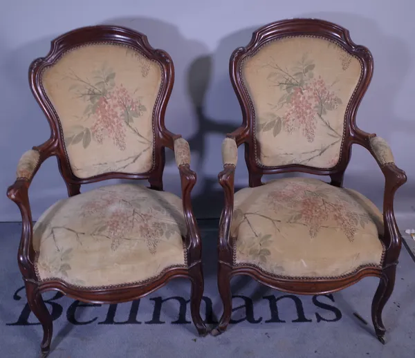 A pair of 19th century mahogany framed open armchairs, on scroll supports, 60cm wide x 99cm high, (2).