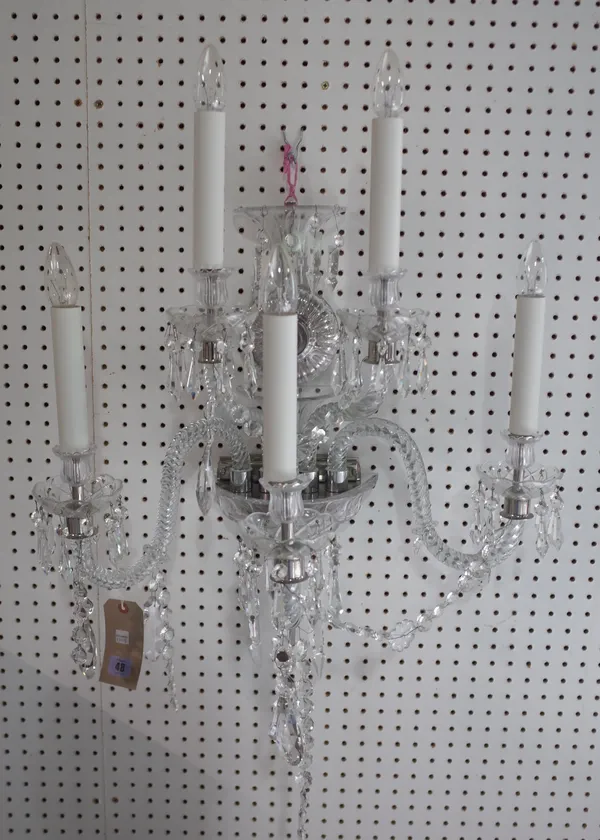 A modern five branch crystal wall applique, silvered embellishments with a circular back plate issuing five spiral twist, swan neck arms and hung with