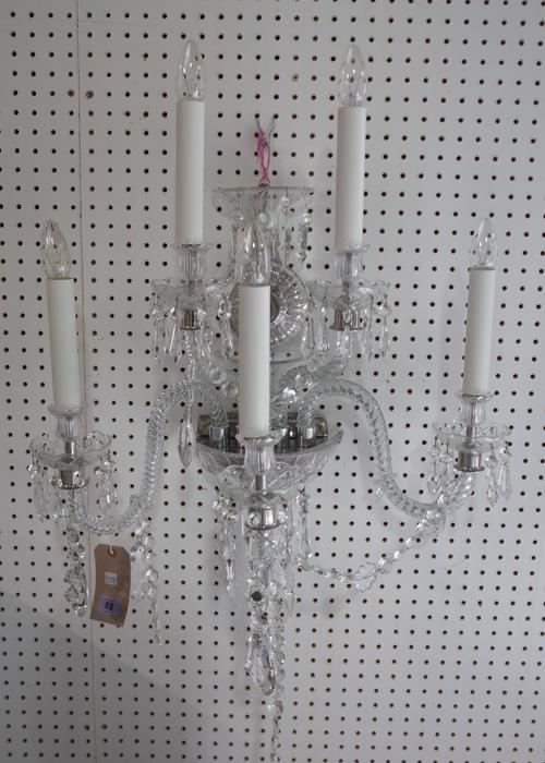 A modern five branch crystal wall applique, silvered embellishments with a circular back plate issuing five spiral twist, swan neck arms and hung with