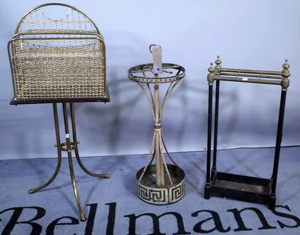 An Edwardian brass and ebonised four division magazine rack, 37cm wide x 86cm high, a circular tôle peinte umbrella stand with green Greek key pattern