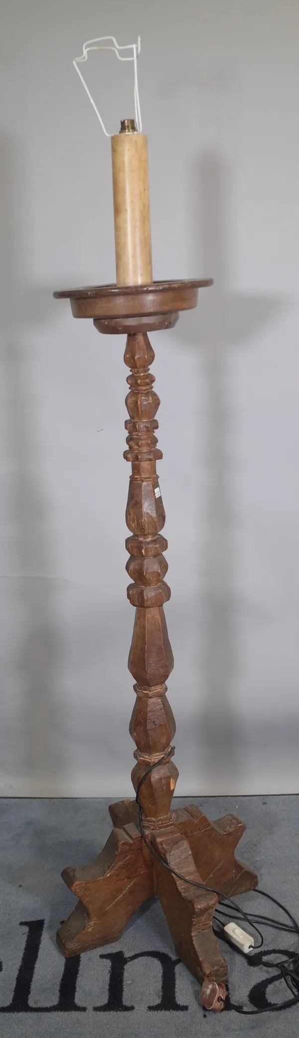 A 17th century Italian style carved walnut standard lamp, 129cm high excluding fitment.