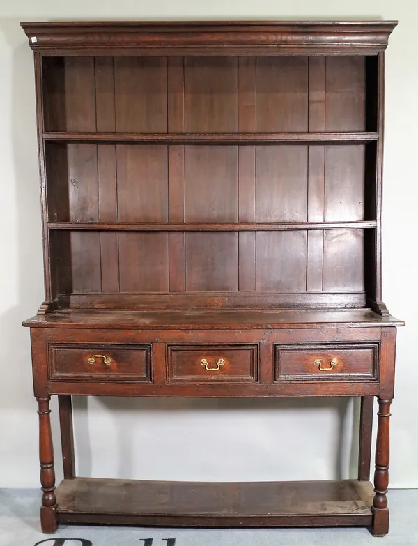 An 18th century and later oak dresser, the enclosed two tier plate rack over three frieze drawers, on turned supports, united by potboard undertier, 1