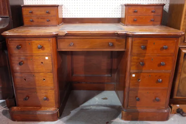 A Victorian mahogany writing desk, with four drawer superstructure over seven drawers about the knee, 138cm wide x 60cm deep.