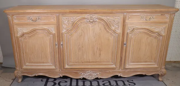 A Victorian style limed oak side cabinet, with two drawers over three panelled doors, 199cm wide x 98cm high.