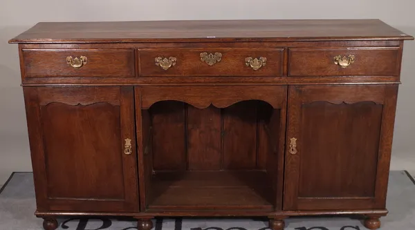 An 18th century style oak dresser base, with three drawers over a cupboard base, 152cm wide x 84cm high.