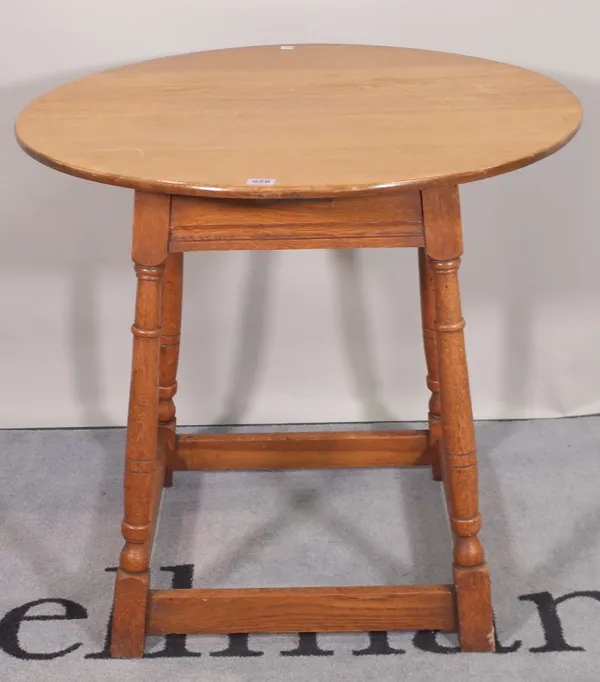 A 20th century oak circular side table, on tapering supports, 75cm wide x 70cm high.