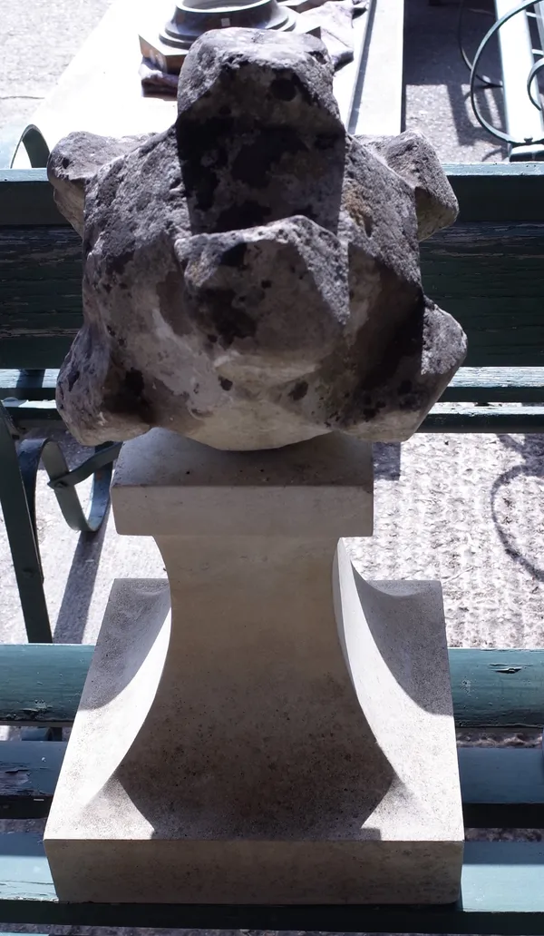 An early 20th century carved stone polyhedron on a later base, 62cm high, and a bronze sundial plate, 26cm wide, (2).