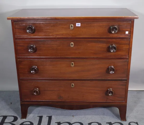 A late George III inlaid mahogany desk, of four long graduated drawers, on splayed bracket feet, 96cm wide x 91cm high.