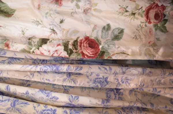 A pair of lined blue foliate curtains, 140cm wide x 252cm long, and a single lined and interlined curtain with rose decoration, 87cm wide x 235cm long