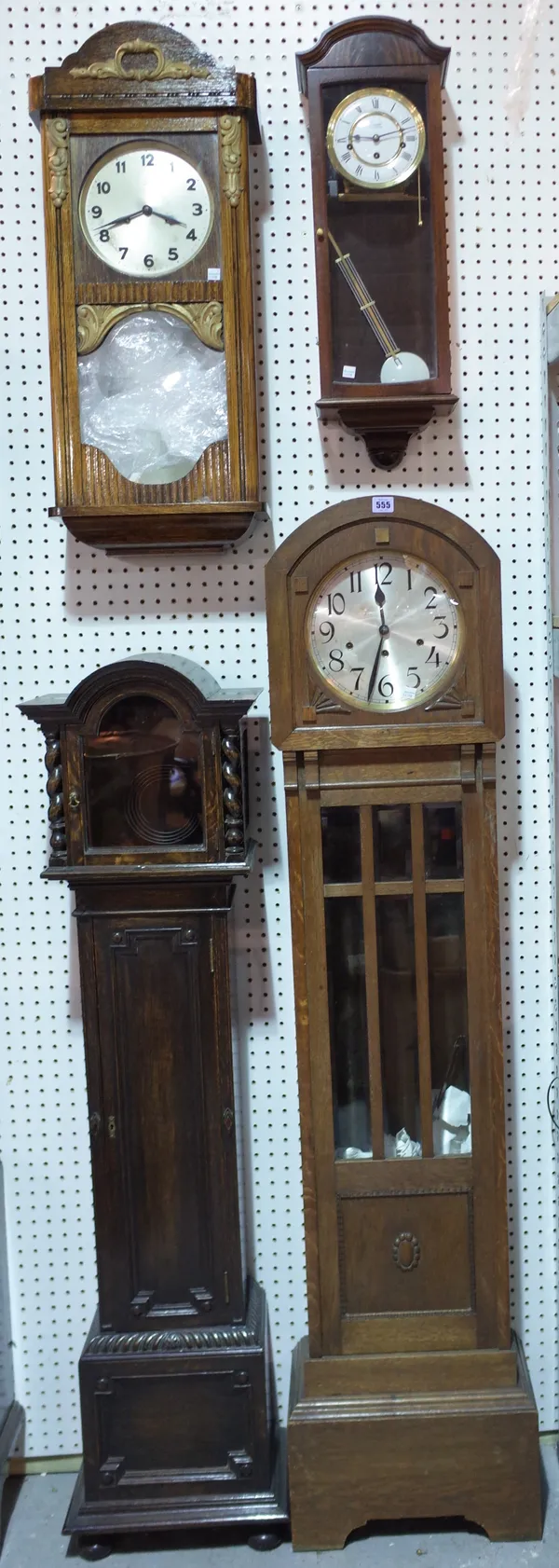 A group of four 20th century clocks, comprising; two mahogany longcase clocks and two mahogany eight day wall clocks, (4).