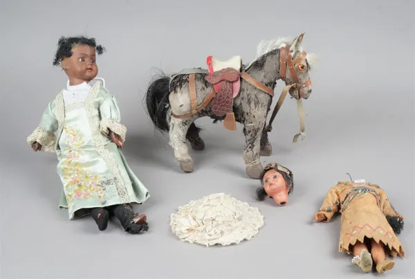 A German bisque head doll, black face, glass eyes and open mouth with jointed wooden limbs, mould no 193, 38cm, another bisque head doll and a stuffed