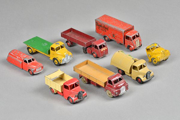 Seven Dinky die-cast commercial vehicles including; Guy 'Slumberland' van, Big Bedford flathead truck, Comet flatbed and four further, (7).