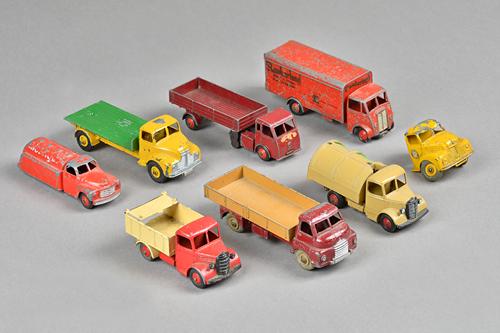 Seven Dinky die-cast commercial vehicles including; Guy 'Slumberland' van, Big Bedford flathead truck, Comet flatbed and four further, (7).
