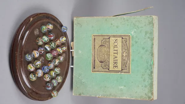 F. H. Ayres Ltd, Solitaire game, late 19th century, with original contents, mahogany board, 30.5cm diameter and thirty-three marbles, boxed.