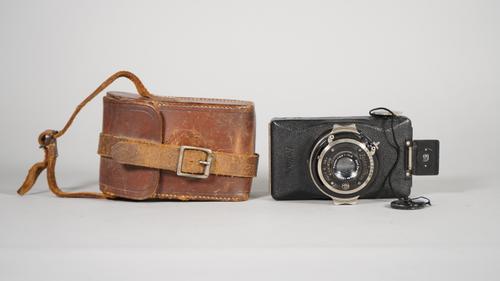 A ZEISS IKON KOLIBRI, 127mm roll film camera, 1930 - 1935, with Carl Zeiss Jena f3.5 50mm lens, contained in original leather case with carrying strap
